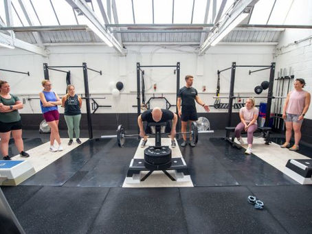 A professional fitness coach training an all-women class