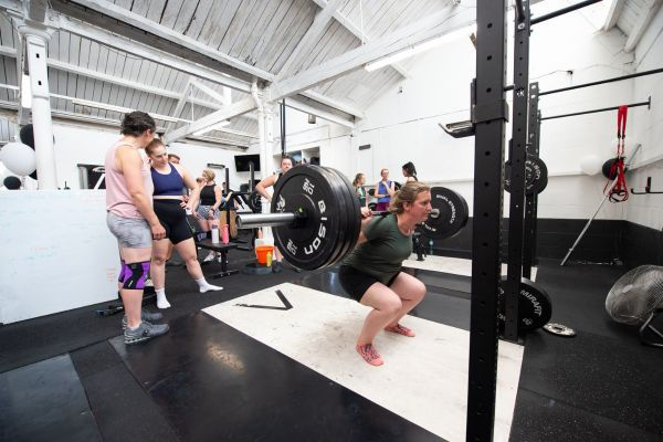 One of the women taking part in the event with an impressive heavy squat.