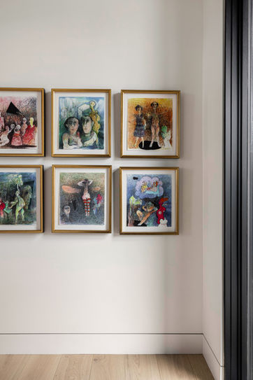 Curated gallery wall with framed artwork inside the Axis custom mountain home