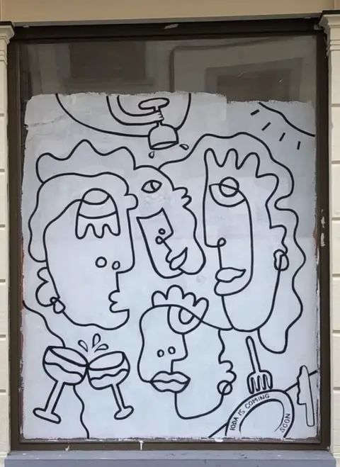 Window Decoration Painting with Abstract Faces on White Wall Posca Illustration in Brussels by Kelly Becker