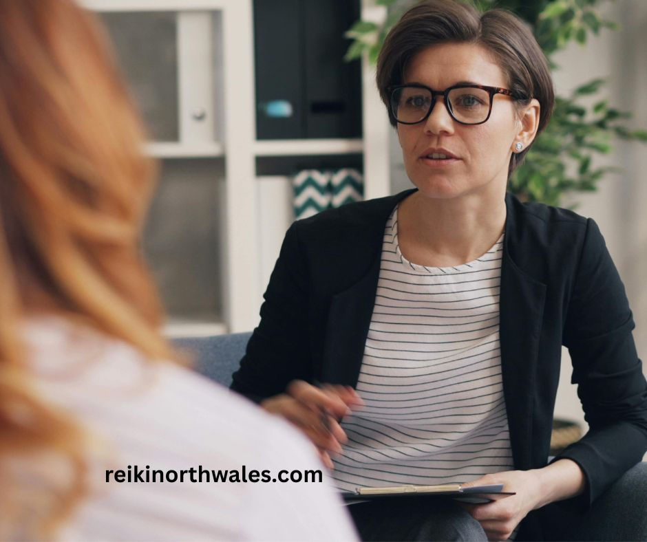 therapist attentively listening to client in Reiki consultation