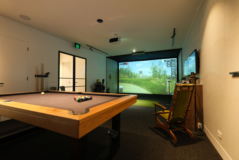 Luxury home golf simulator installation with GSPro screen, ambient lighting, and pool table for dual-purpose entertainment space — designed by Golfsim Australia.