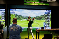 Golf group using a premium indoor golf simulator setup with GSPro software and launch monitor data displayed on a large impact screen — custom install by Golfsim Australia.