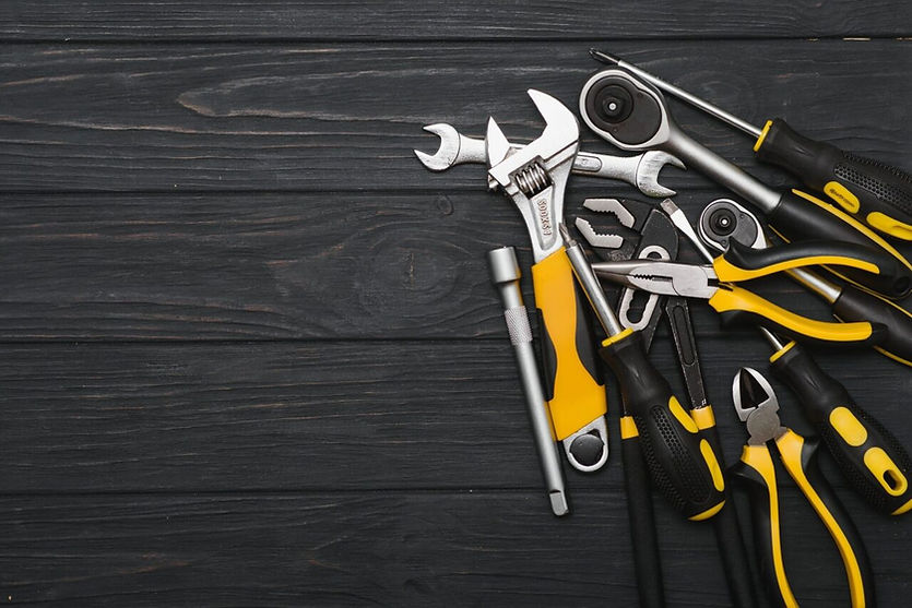 set-of-assorted-work-carpentry-and-locksmith-tools-on-a-dark-wooden-background-with-copy-s