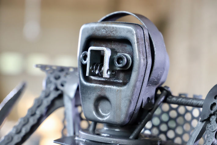 Tête en gros plan et détaillée d'une sculpture en métal représentant un robot guerrier