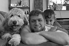 Family laying with their dog on the couch