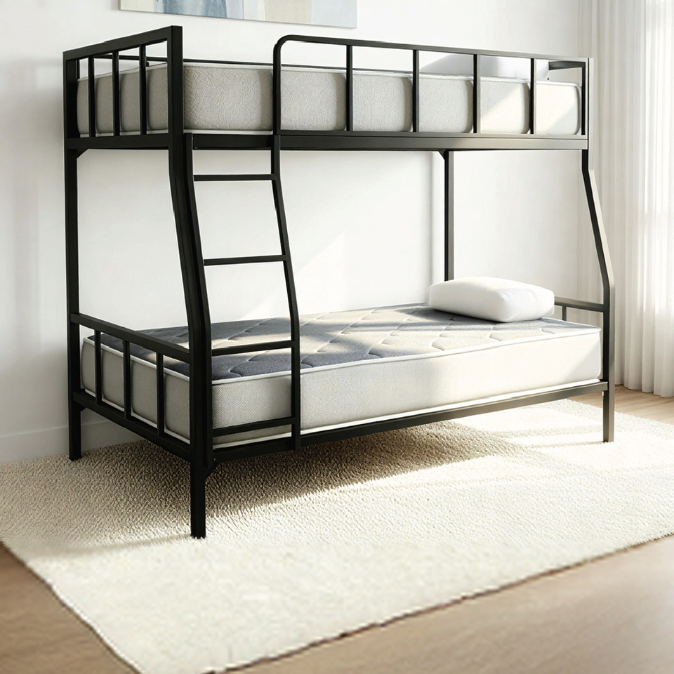 Side view of the black metal DrM Furniture BUNK bed with Barrier in a bright, styled room.
