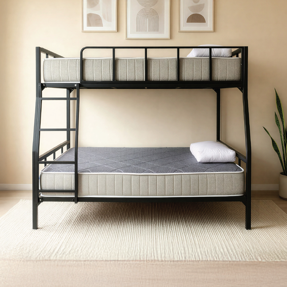 Front view of the black metal DrM Furniture BUNK bed with Barrier in a styled room.