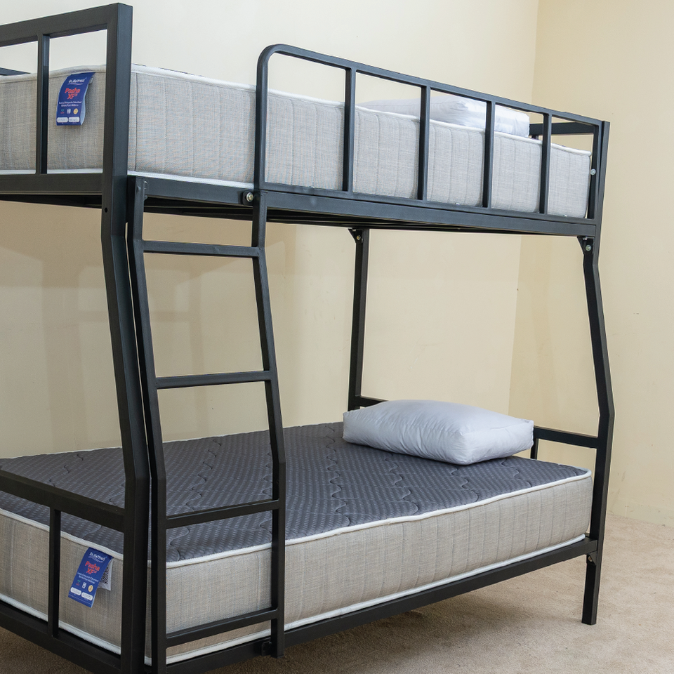 Close-up angled view of the black metal DrM Furniture BUNK bed with Barrier and ladder detail.