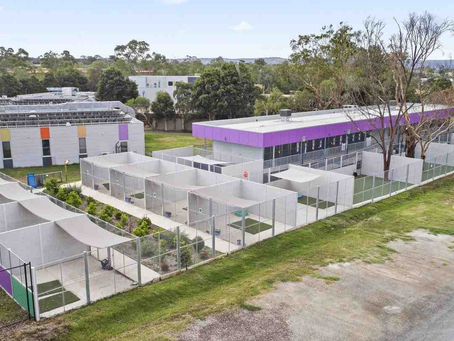 Aerial view of a large commercial facility requiring industrial gate installation and secure perimeter fencing.