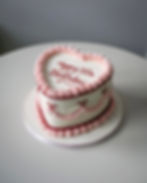 Piped vintage bow heart cake