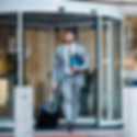businessman-outside-office-suitcase-and-travel-fo-2026-01-09-09-24-54-utc.jpg