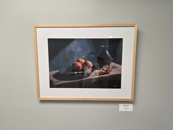 Freeman Long's still-life photography of an orange, orange slices, and a vase.