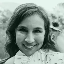 Smiling woman holding a young child outdoors