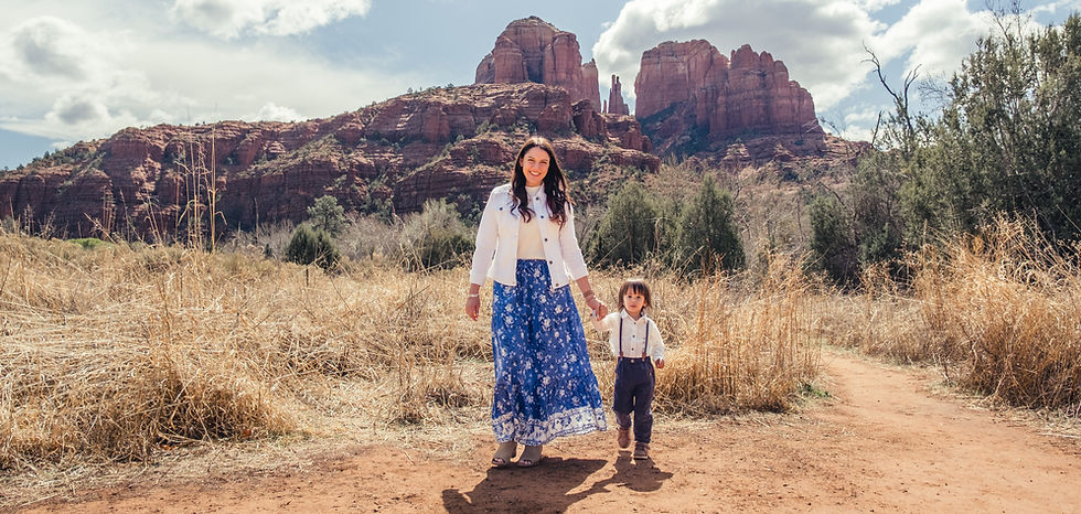 Erica Liu and her son walking together beside red rock formations
