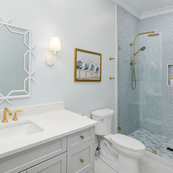 Luxury bathroom featuring double vanity, custom mirrors, and freestanding soaking tub