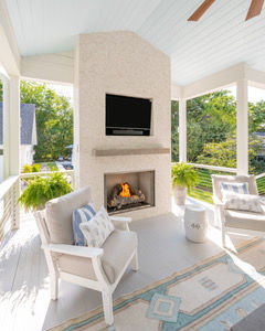 Custom outdoor fireplace creating a comfortable gathering space within a thoughtfully designed Charleston outdoor living project.