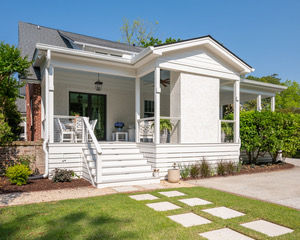 Exterior view of a custom outdoor living addition in Charleston's Windermere neighborhood featuring a covered patio designed to complement the home's historic architecture.