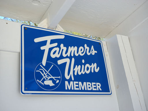 A blue Farmers Union member sign