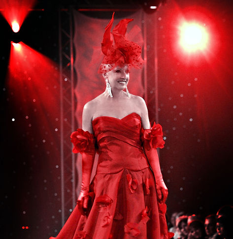 Model in a red dress by Richard Robinson, Master Couturier.