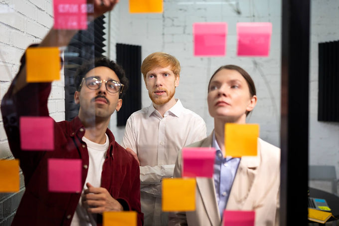 people analyzing sticky notes with SWOT