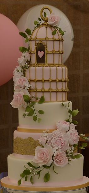 Pink and gold bird cage wedding cake
