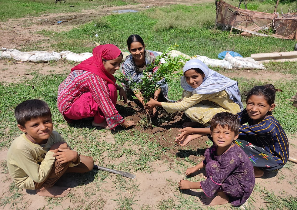 Aamna, Salma and Naseema planting a tree with children