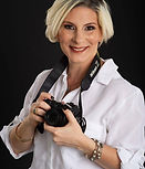 Smiling woman photographer holding a camera