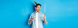 happy-young-man-celebrating-birthday-party-hat-holding-bday-cake-smiling-standing-blue-b.j