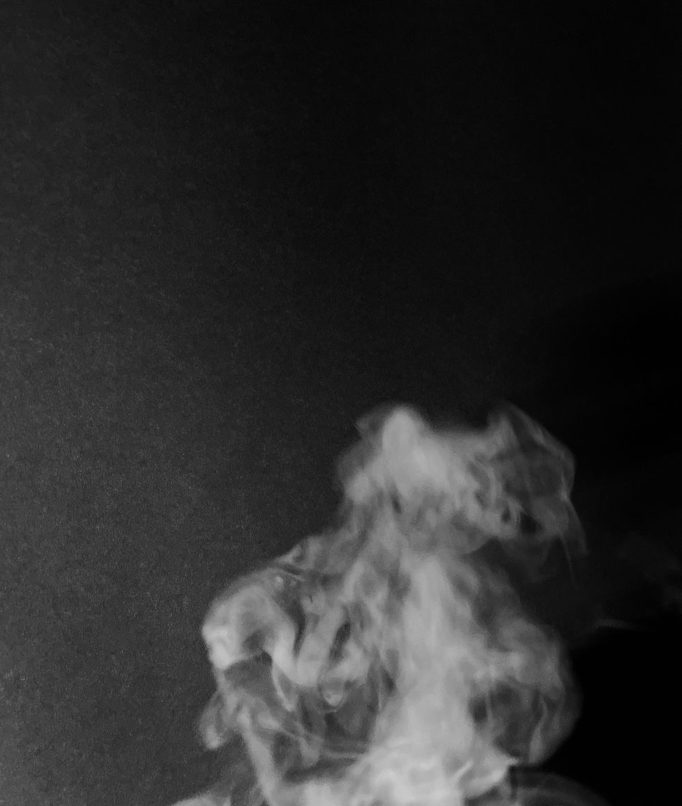 The smoke moves through the empty space, creating a sense of motion as it rises and spreads. It being in black and white it highlights the difference between the smoke and the negative space, emphasizing movement.
