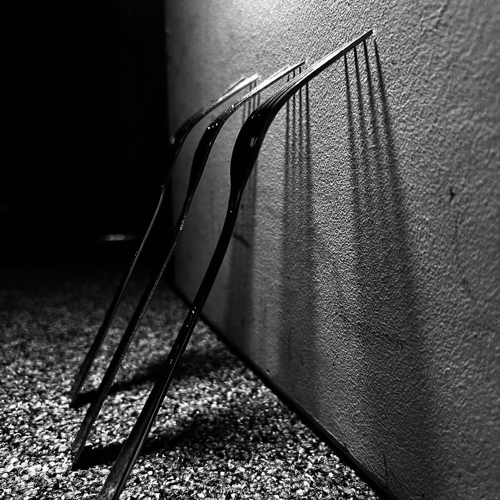 The forks create apparel lines that give a cool look going down the wall. The black and white emphasizes their shape and the spaces between them.