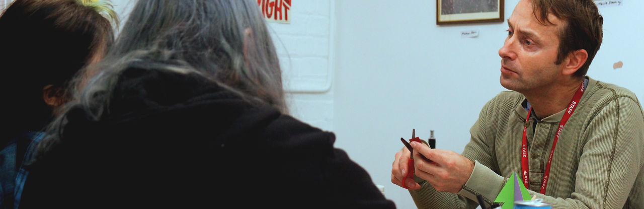 Art and Design Teacher helping two students