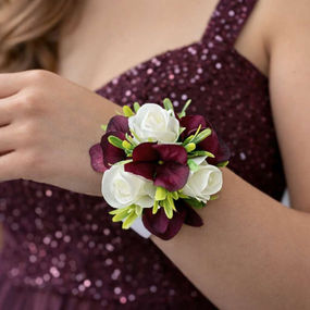 Burgundy And White Corsage on wrist of girl going to prom