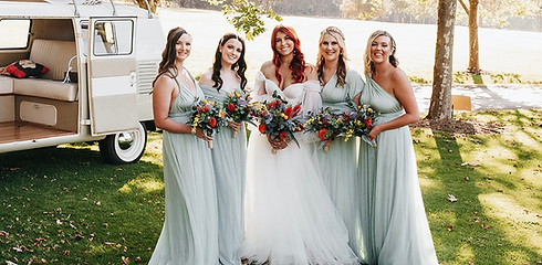 Bride and bridesmaids holding artificial wedding bouquets.