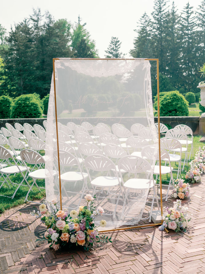 Sheer fabric wedding sign in New York, with "All Because Two People Fell In Love" text.