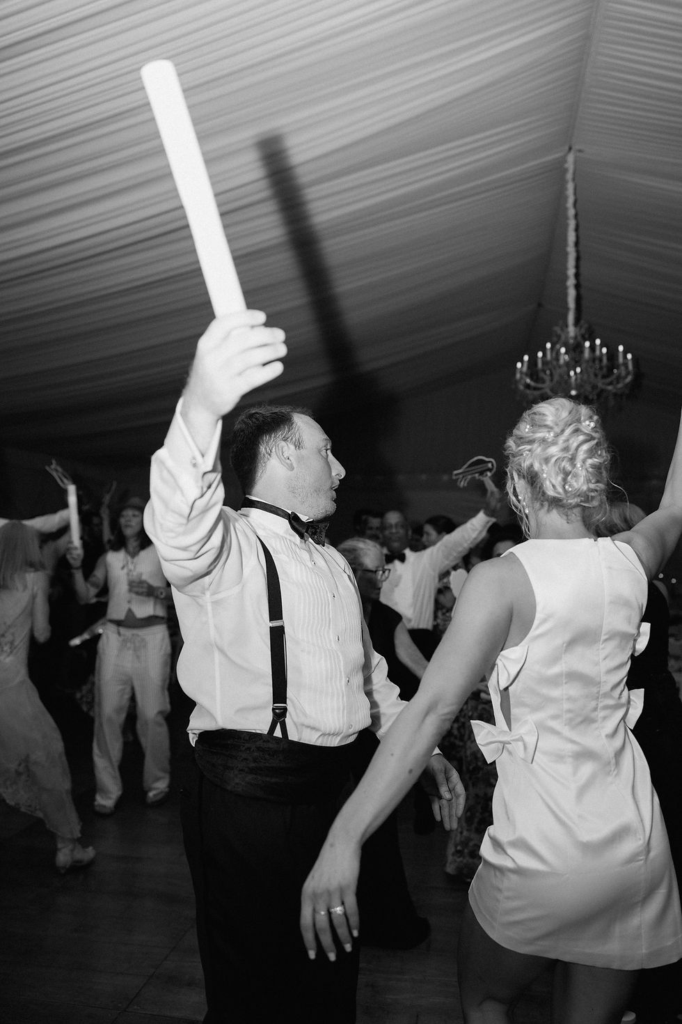 Black and white photo of bride and groom dancing together during wedding reception in Rochester New York