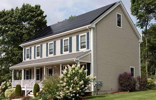 Vivint Solar - Solar Panels on a beautiful home with green lawn and bushes_edited.jpg