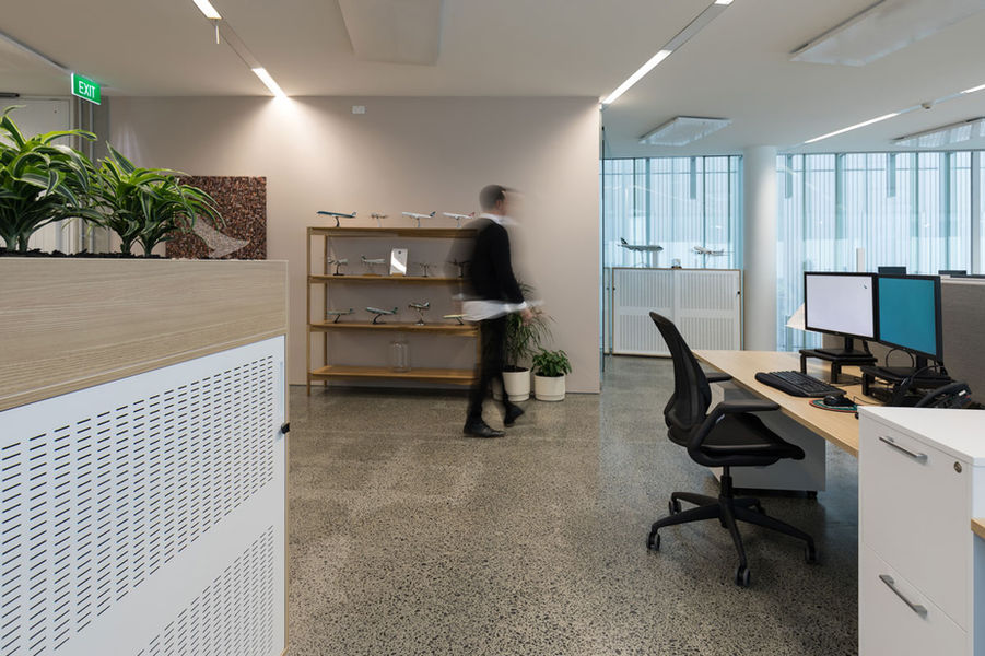 Minimalist office space with curved walls and calming tones for Cathay Pacific.
