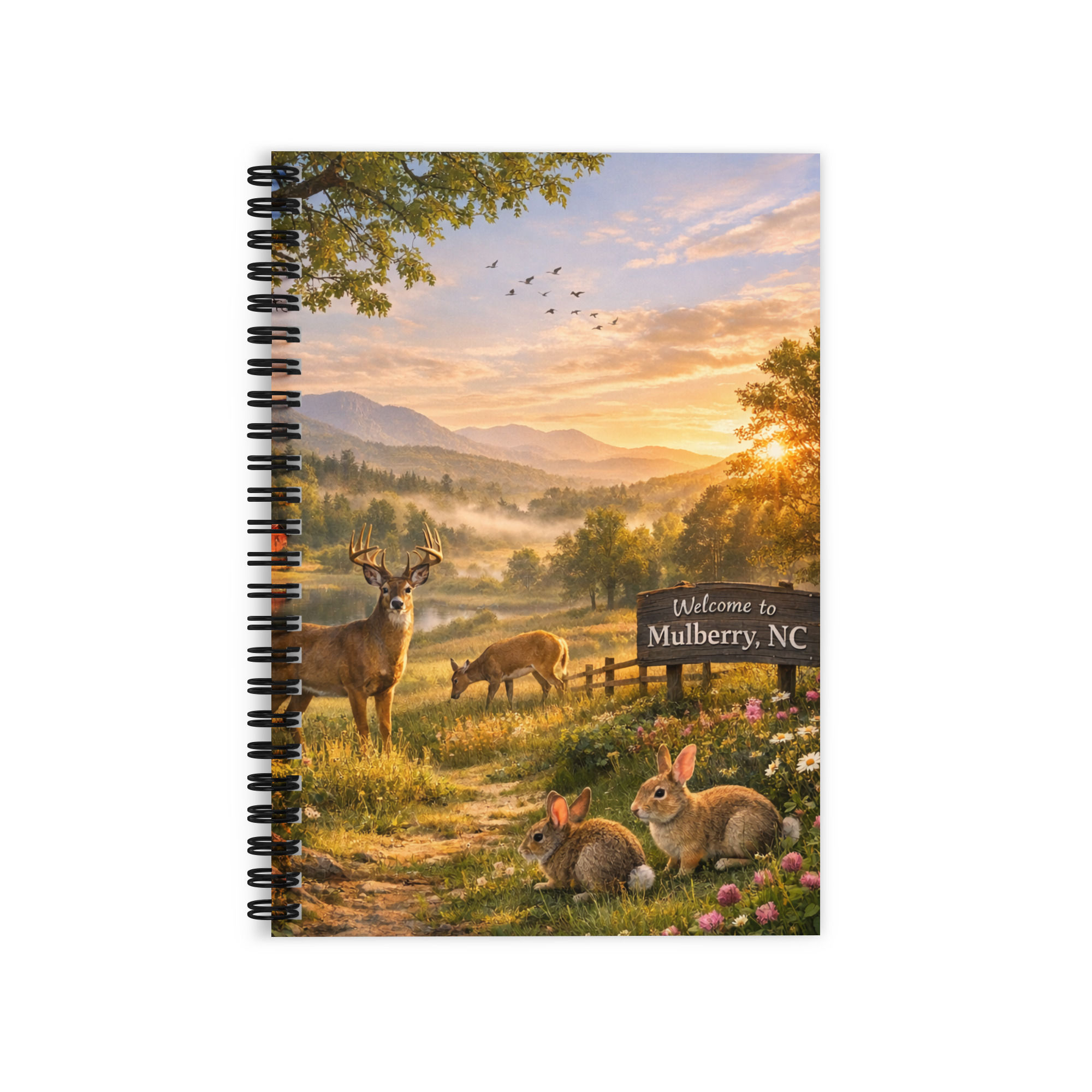 Spiral notebook cover with deer, rabbits, and mountains at sunrise