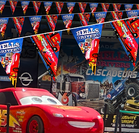 Cars the movie Custom Pinted Bunting shown in front of a stunt show and featuring lightning McQueen the famous red car.png