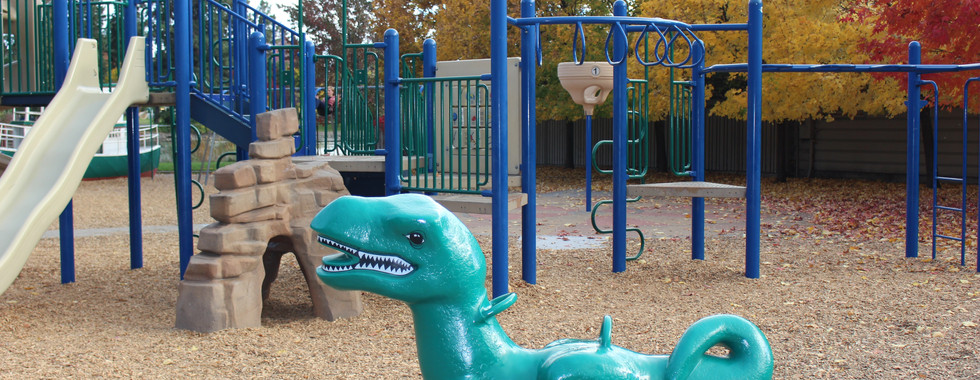Harmon park playground in Bend, Oregon dinosaur and climbing structure