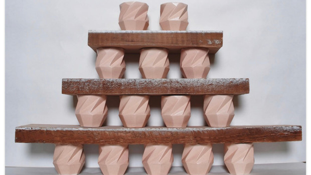 Geo cups stacked up four levels high on top of each other.
