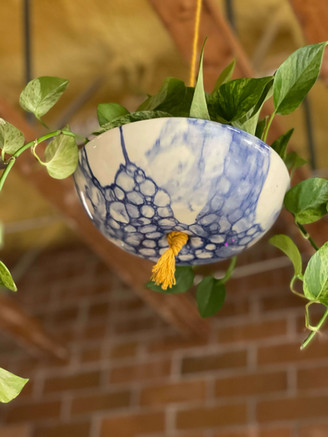 White and blue speckled plant pot made by James Kemp.