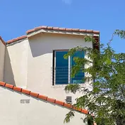 Second story room addition with structural framing and modern finished exterior.