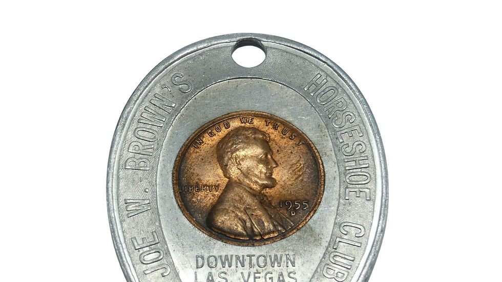 1955 D wheat penny encased in a Joe W. Brown’s Horseshoe Club collectible holder