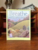 The book standing on a table. On the cover a boy is blowing a dandelion.