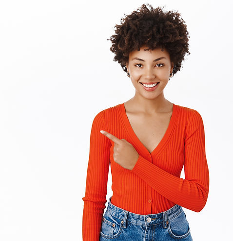 Smiling african american woman in stylish outfit, pointing finger left, showing promotion