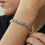 Thumbnail: Model wearing the Juno bracelet, a textured sterling silver bangle