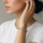 Female Model wearing the Juno bracelet, a textured sterling silver bangle