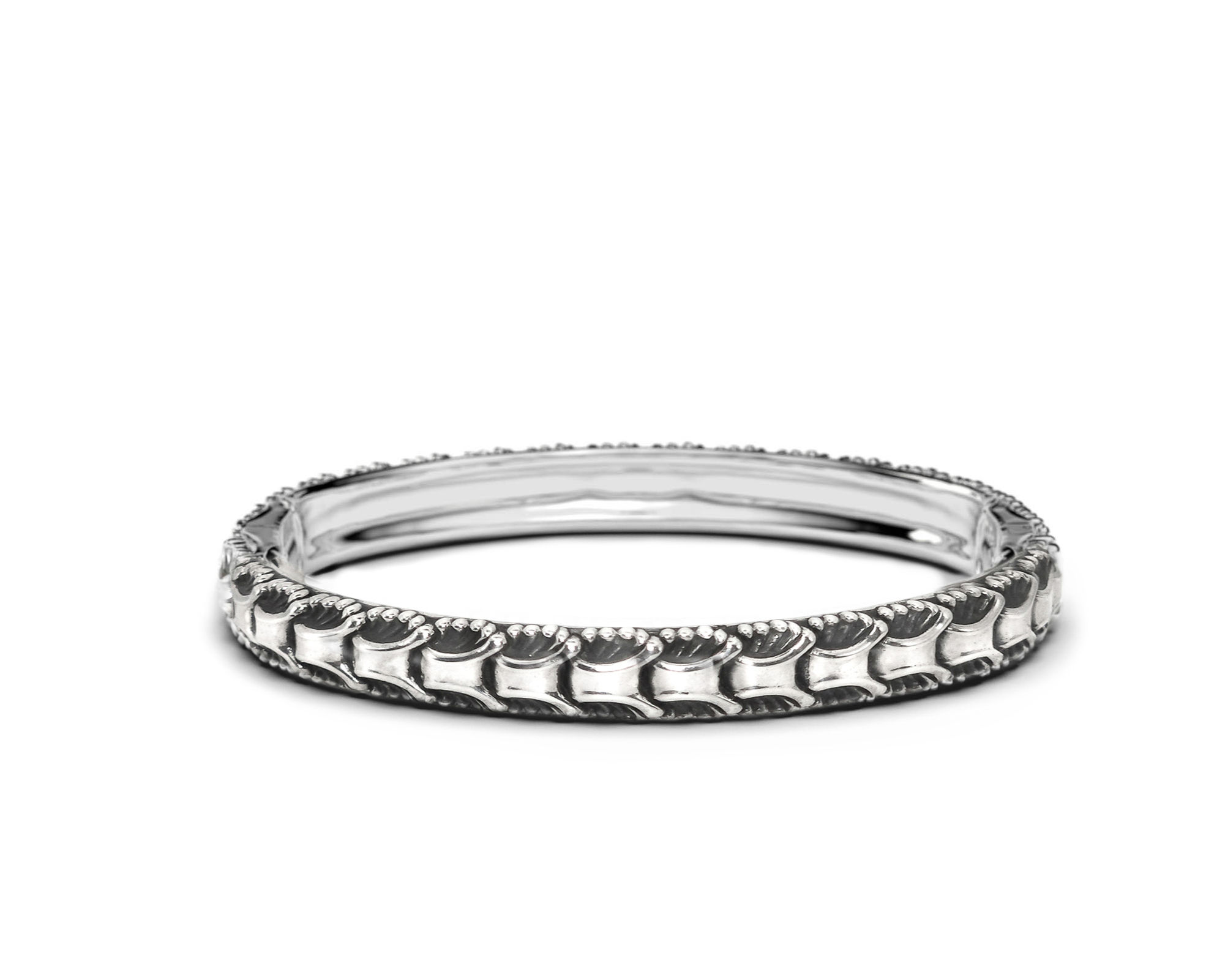 Sterling silver Anemone bangle bracelet on a white surface